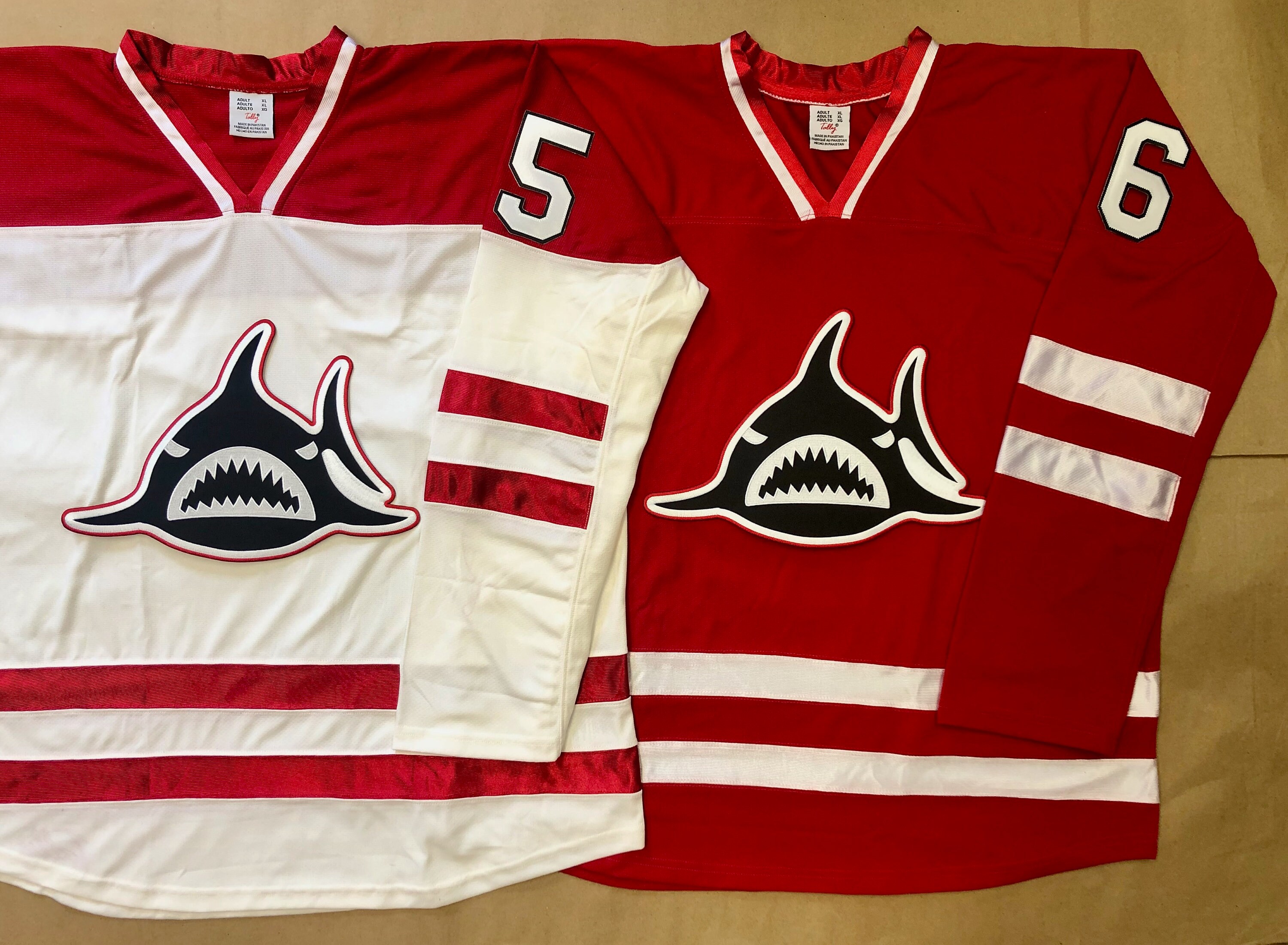 Red and White Hockey Jerseys with a Shark Crest
